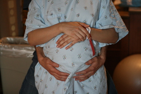 Doula support helps couple work together to manage contractions during labor.